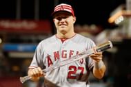 Mike Trout holding the MVP trophy, which is named after Ted Williams.